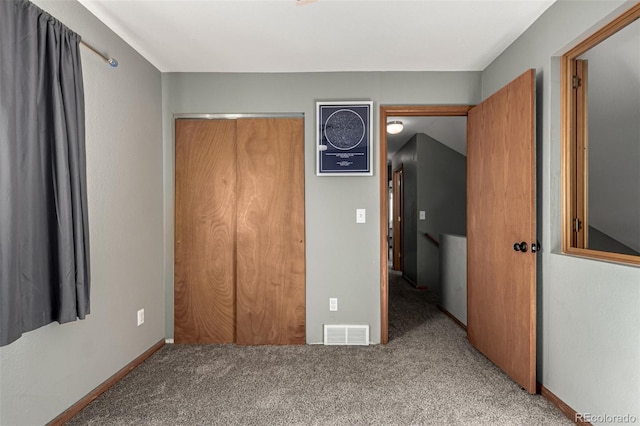 unfurnished bedroom with a closet and carpet floors