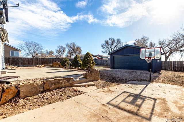 view of patio / terrace featuring a garage and an outbuilding