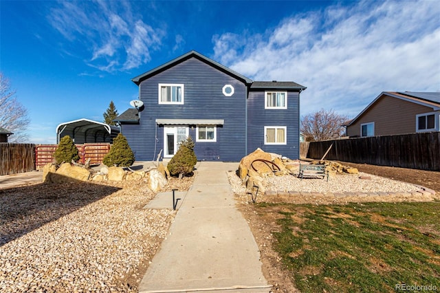 rear view of property with a carport