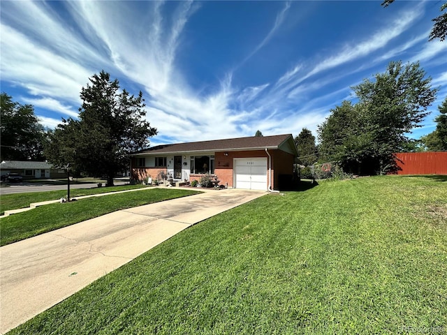 single story home featuring a garage and a front lawn