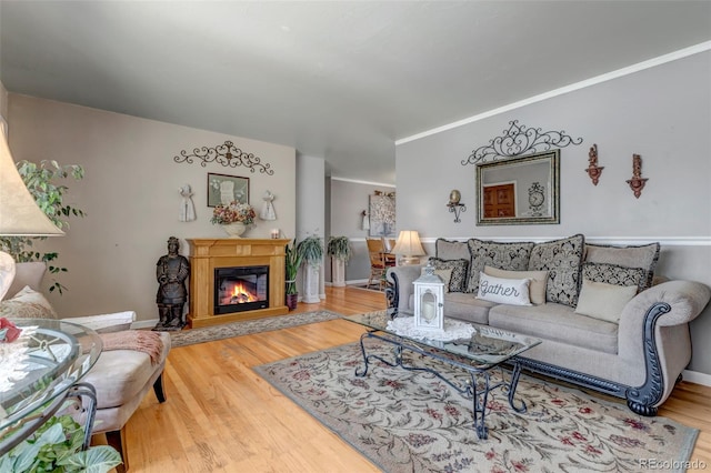 living room with hardwood / wood-style flooring and crown molding