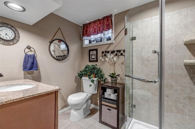 bathroom with vanity, toilet, and a shower with door