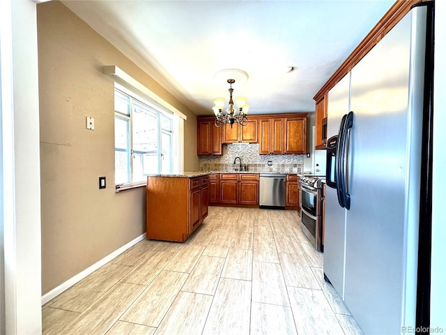 kitchen featuring pendant lighting, sink, appliances with stainless steel finishes, tasteful backsplash, and a notable chandelier