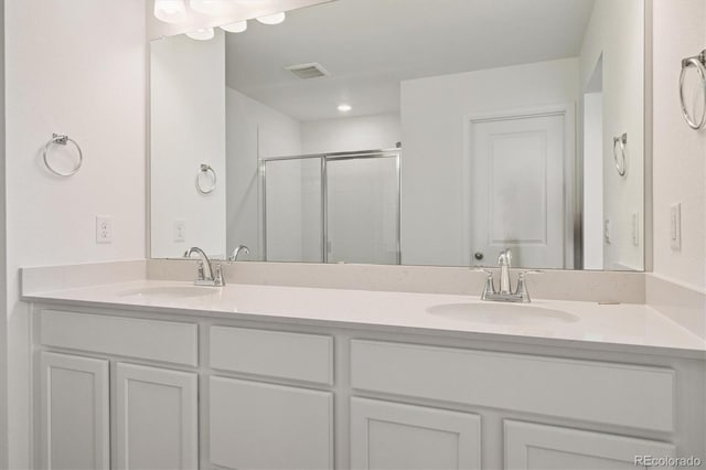 8339 Snake River St, Littleton, CO 80125 - bathroom featuring double vanity and a shower stall