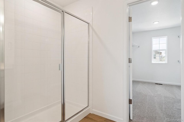 8339 Snake River St, Littleton, CO 80125 - bathroom with a stall shower, a spacious closet, and recessed lighting