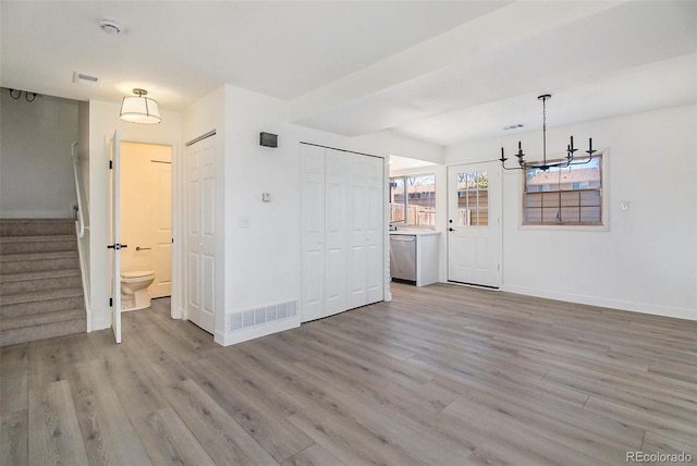 interior space featuring light hardwood / wood-style flooring and a notable chandelier