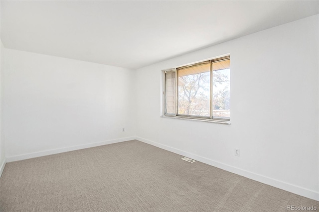 unfurnished room featuring carpet