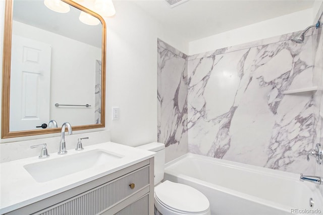 full bathroom featuring vanity, tiled shower / bath combo, and toilet