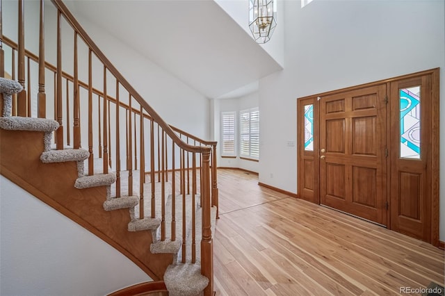 5416 S Hannibal Ct, Centennial, CO 80015 - entryway featuring a towering ceiling, stairway, wood finished floors, and a chandelier