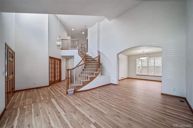 5416 S Hannibal Ct, Centennial, CO 80015 - entryway with a towering ceiling, wood finished floors, french doors, arched walkways, and stairway