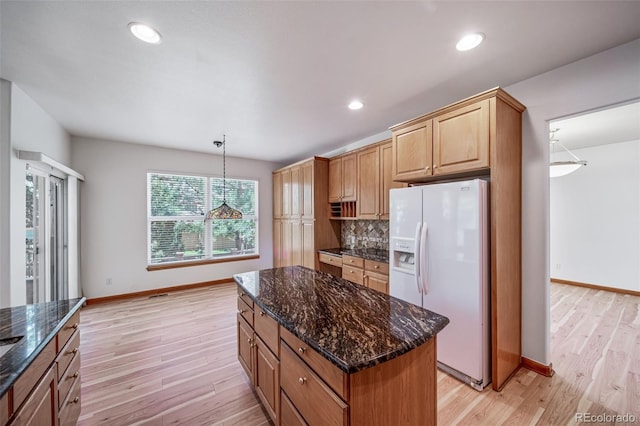 5416 S Hannibal Ct, Centennial, CO 80015 - kitchen with white fridge with ice dispenser, light wood-style floors, backsplash, dark stone countertops, and recessed lighting