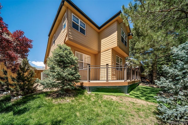 5416 S Hannibal Ct, Centennial, CO 80015 - rear view of property featuring a wooden deck and a lawn