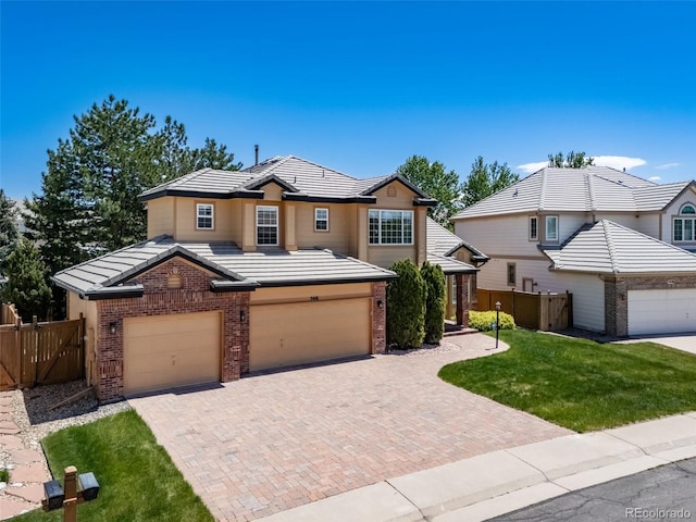 5416 S Hannibal Ct, Centennial, CO 80015 - traditional-style house with brick siding, decorative driveway, an attached garage, and a tile roof
