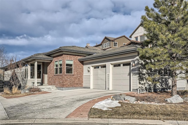 view of front of house featuring concrete driveway, brick siding, and an attached garage