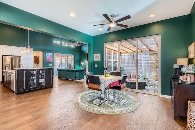 dining area with light wood-type flooring, a ceiling fan, a wealth of natural light, and recessed lighting