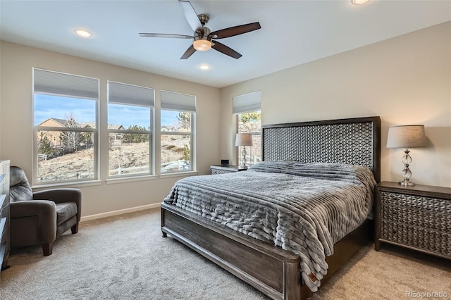 bedroom featuring a ceiling fan, recessed lighting, light colored carpet, and baseboards