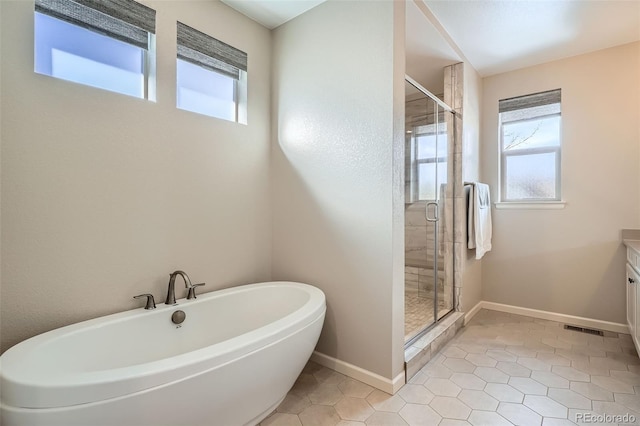 full bathroom with a soaking tub, visible vents, a shower stall, tile patterned flooring, and baseboards