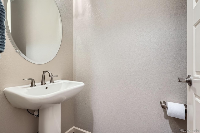 bathroom with a textured wall