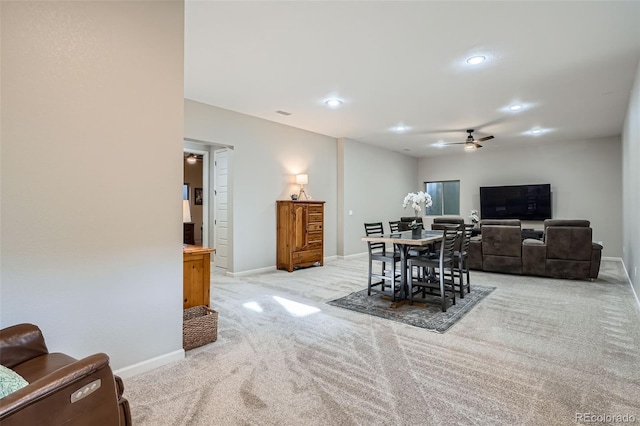 dining space with light carpet, recessed lighting, a ceiling fan, and baseboards