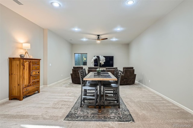 carpeted dining area with ceiling fan, baseboards, and recessed lighting