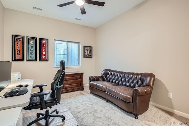 office area featuring ceiling fan, light carpet, visible vents, and baseboards