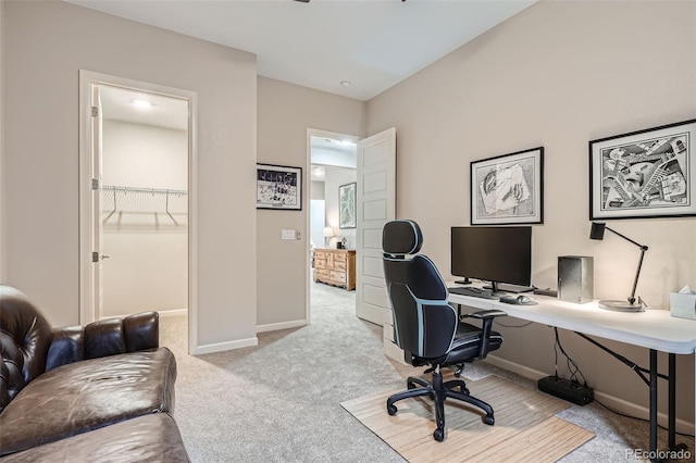 office with baseboards and light colored carpet