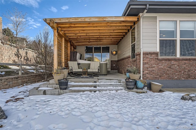 snow covered patio featuring fence