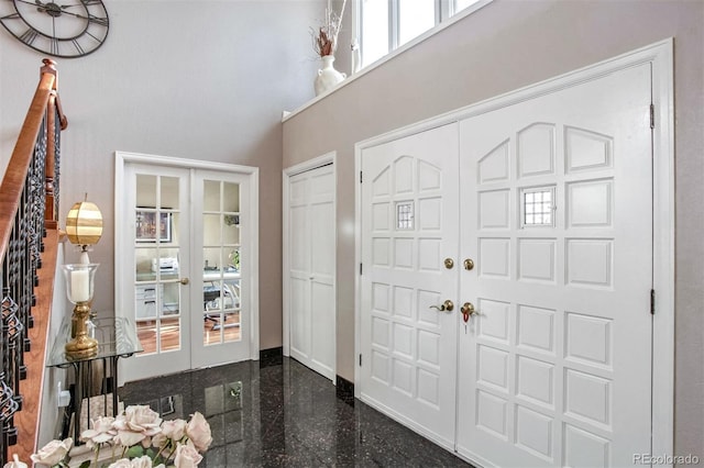 entryway with french doors and a high ceiling