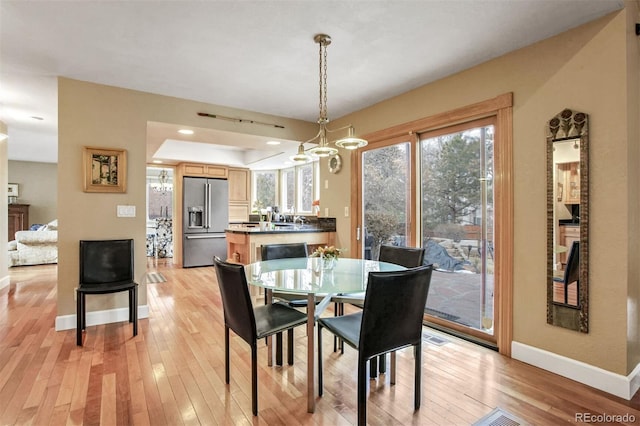 dining room with an inviting chandelier and light wood-type flooring