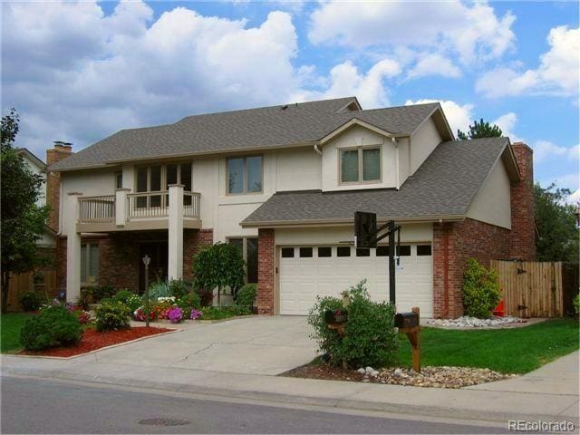 view of front of home featuring a balcony and a garage