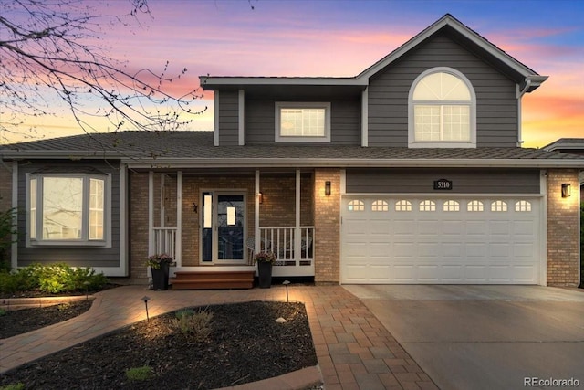 5310 S Flanders Way, Centennial, CO 80015 - traditional home featuring a garage, covered porch, brick siding, a shingled roof, and concrete driveway