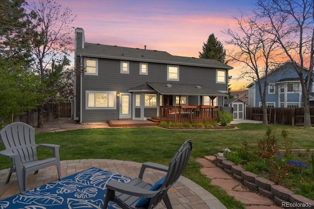 5310 S Flanders Way, Centennial, CO 80015 - back of house featuring a chimney, an outbuilding, a patio area, a fenced backyard, and a storage unit