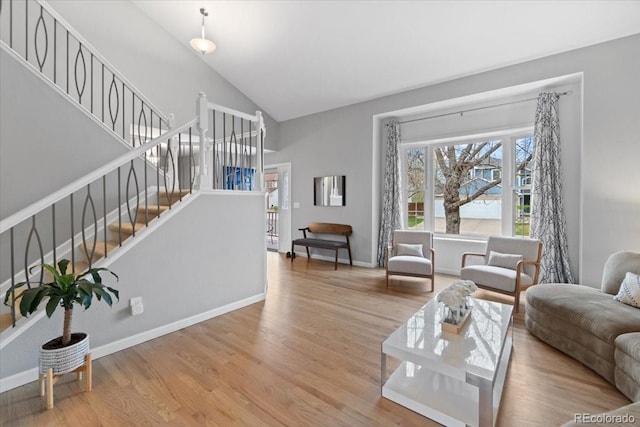 5310 S Flanders Way, Centennial, CO 80015 - living room featuring baseboards, high vaulted ceiling, wood finished floors, and stairway