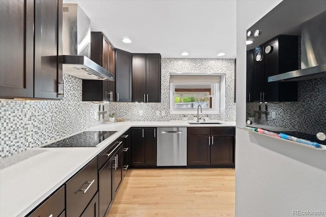 5310 S Flanders Way, Centennial, CO 80015 - kitchen with light wood-style floors, wall chimney exhaust hood, dishwasher, and black electric stovetop