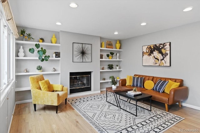 5310 S Flanders Way, Centennial, CO 80015 - living area with recessed lighting, baseboards, a glass covered fireplace, and wood finished floors