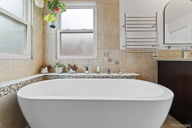 5310 S Flanders Way, Centennial, CO 80015 - bathroom featuring vanity, a freestanding bath, radiator heating unit, and tile walls