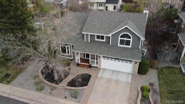 5310 S Flanders Way, Centennial, CO 80015 - traditional-style house with roof with shingles, an attached garage, a chimney, and driveway