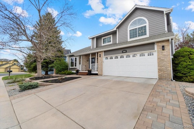 5310 S Flanders Way, Centennial, CO 80015 - traditional home with a garage, concrete driveway, and brick siding