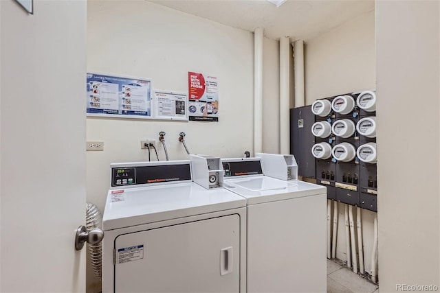 washroom featuring separate washer and dryer and light tile patterned floors