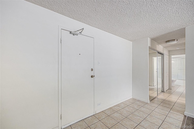 2225 Buchtel Blvd Unit 208, Denver, CO 80210 - empty room featuring a textured ceiling and light tile patterned flooring