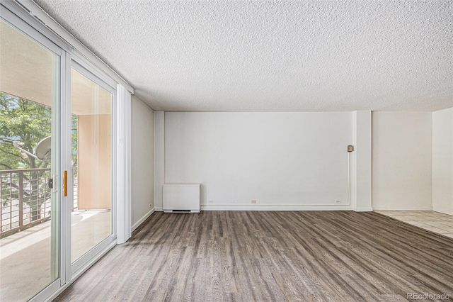 2225 Buchtel Blvd Unit 208, Denver, CO 80210 - empty room with wood finished floors and a textured ceiling