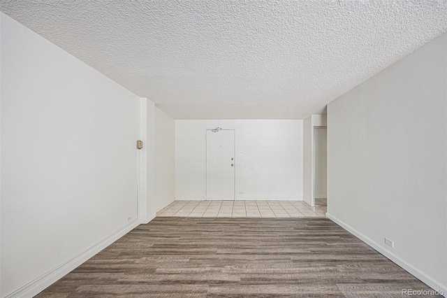 2225 Buchtel Blvd Unit 208, Denver, CO 80210 - corridor featuring a textured ceiling and wood finished floors