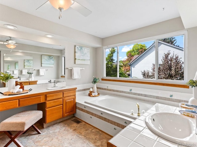 full bath with visible vents, vanity, a bath, and a ceiling fan