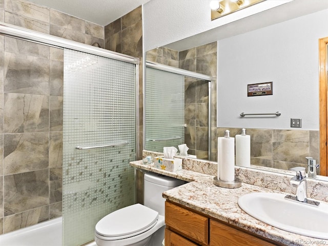 bathroom featuring a stall shower, toilet, and vanity