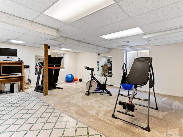 workout area featuring visible vents, light colored carpet, and baseboards