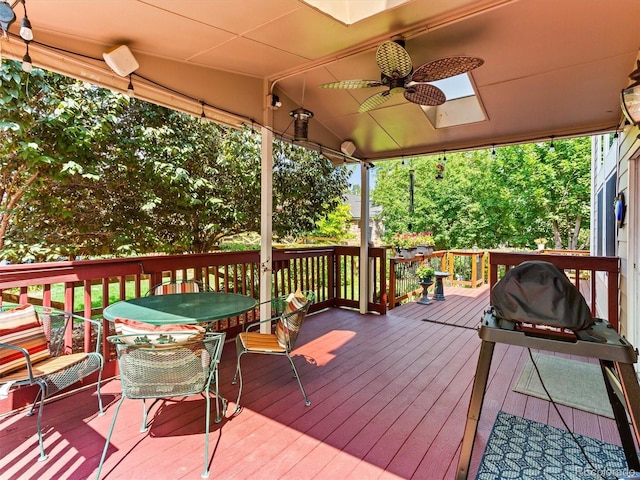 wooden deck featuring a ceiling fan