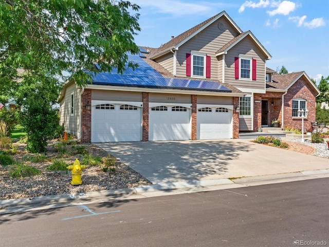 traditional-style home with concrete driveway, a garage, and brick siding