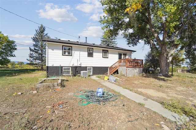 rear view of house with a deck and central AC