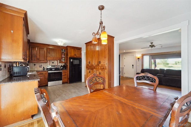 dining room with ceiling fan and hardwood / wood-style flooring