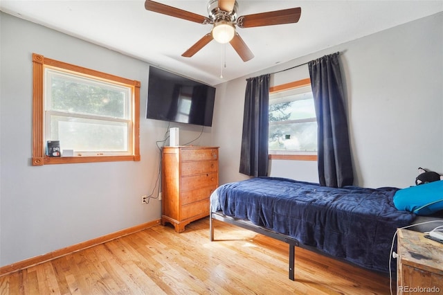 bedroom with ceiling fan and hardwood / wood-style floors